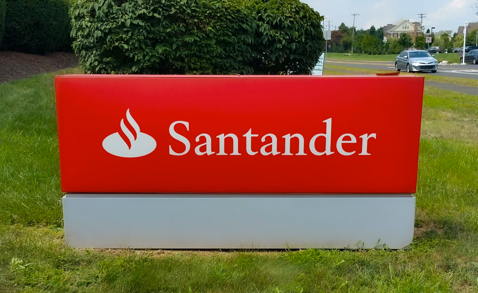 Large, red, aluminum monument sign with vinyled lettering