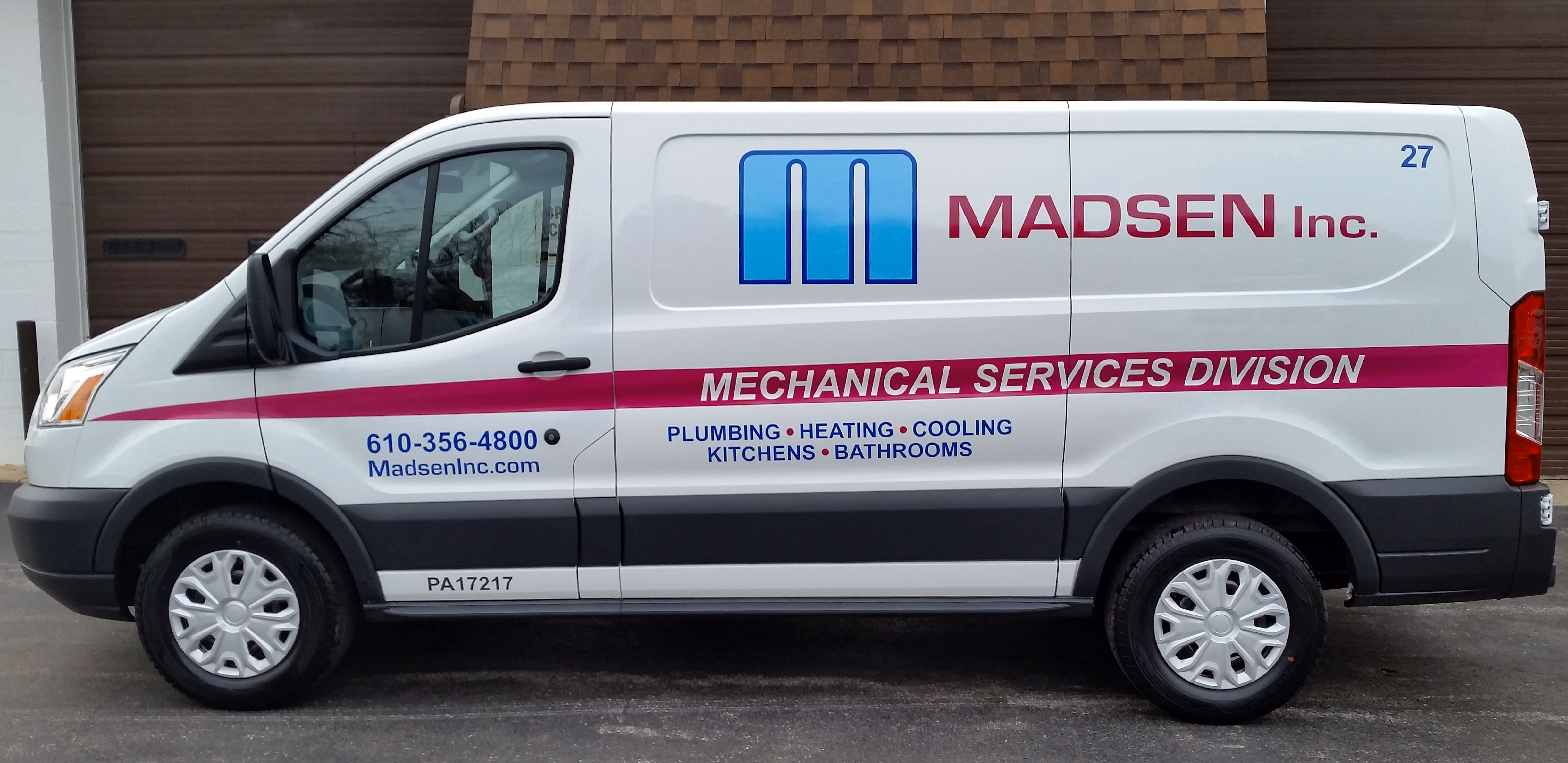 Custom-wrapped service van with vinyl lettering and logo