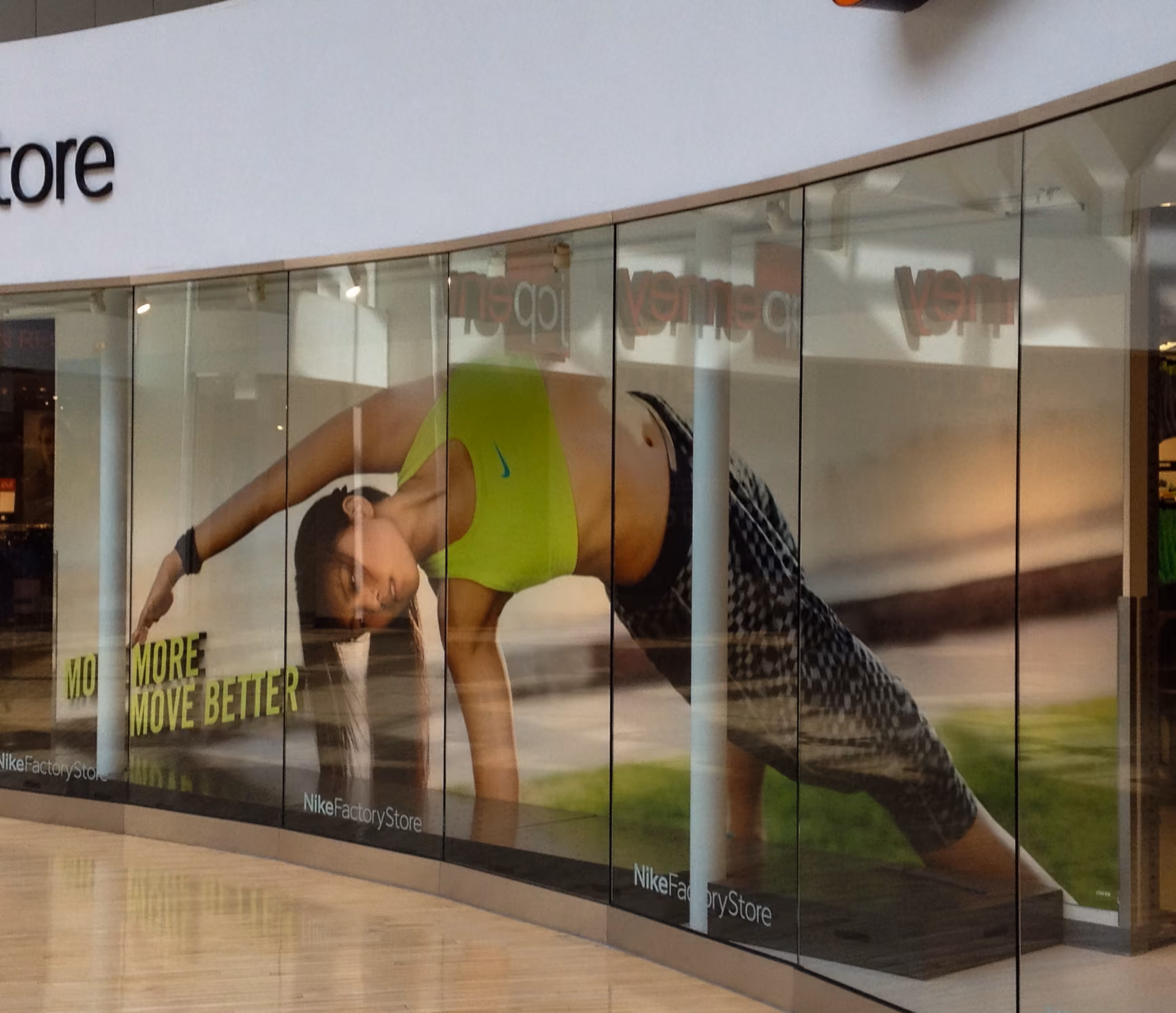 Large vinyl graphic installed inside a mall storefront window