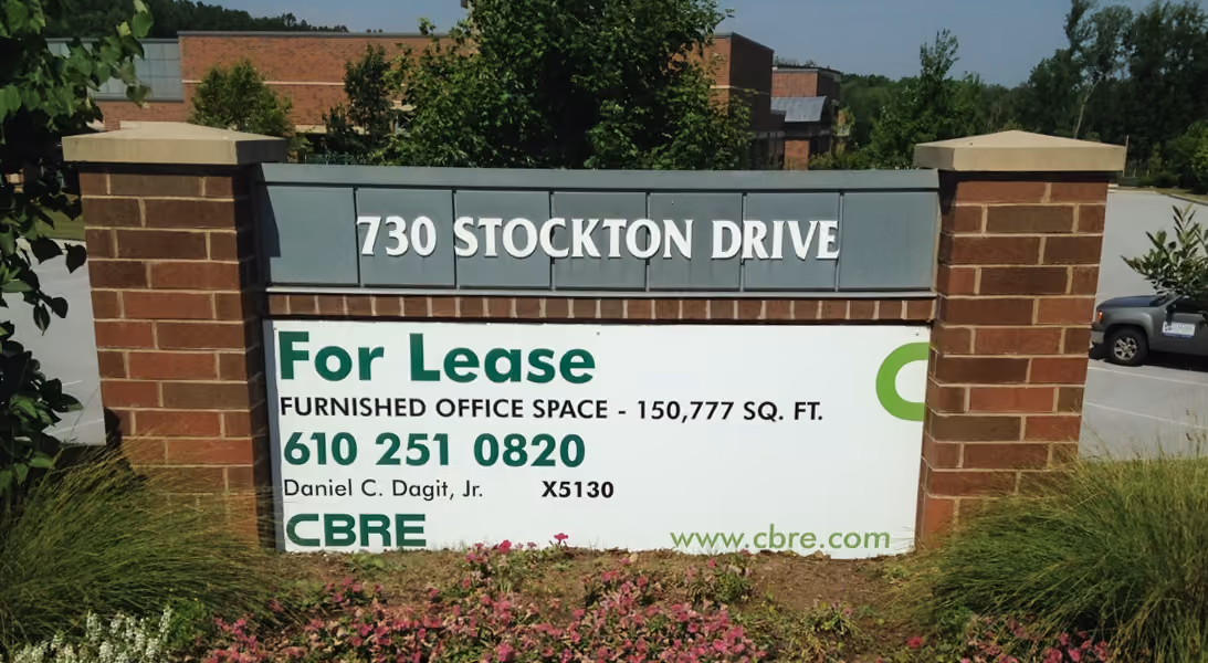 White dimensional letters on a brick monument sign