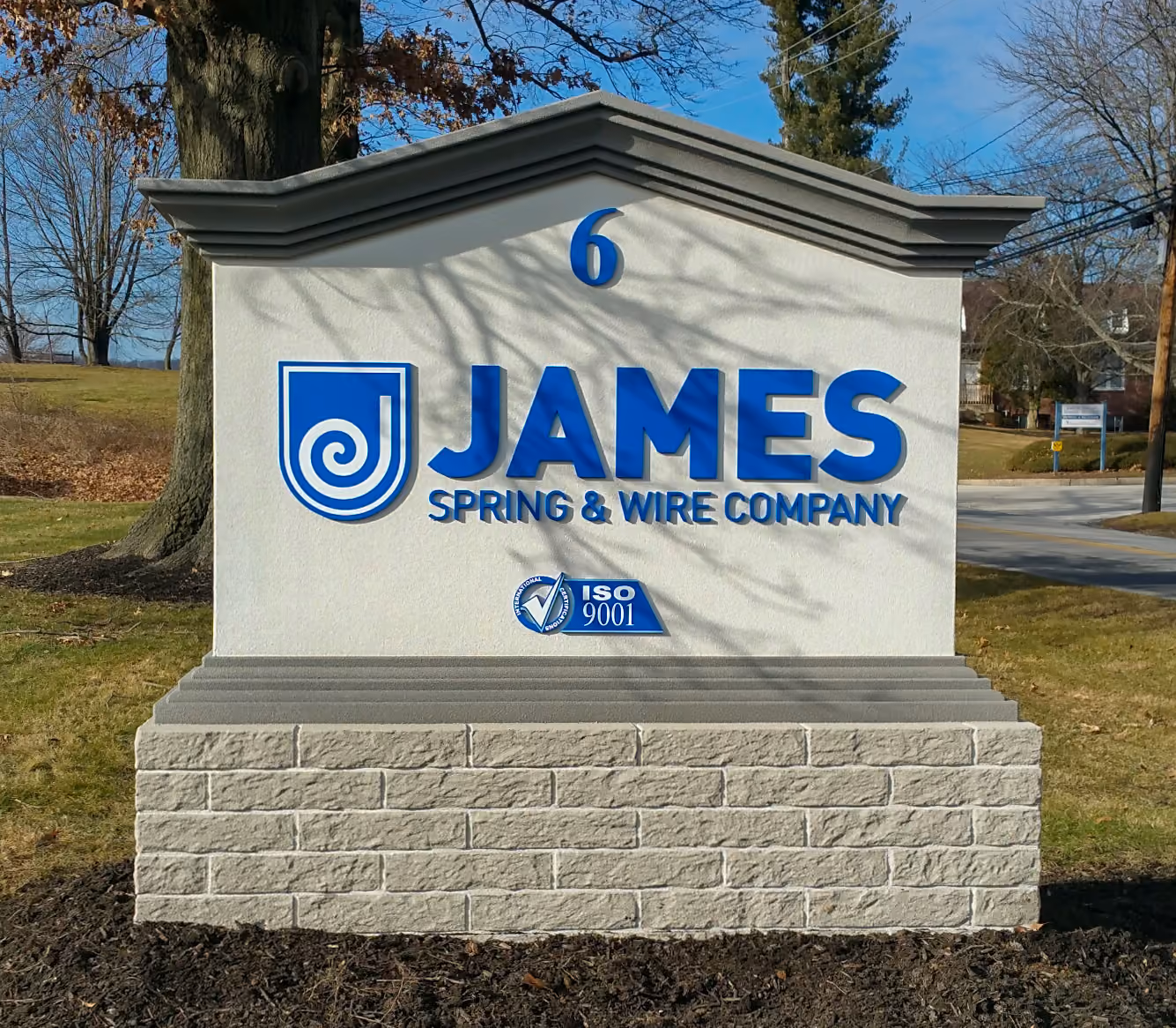 Blue dimensional letters and logo on a masonry monument base