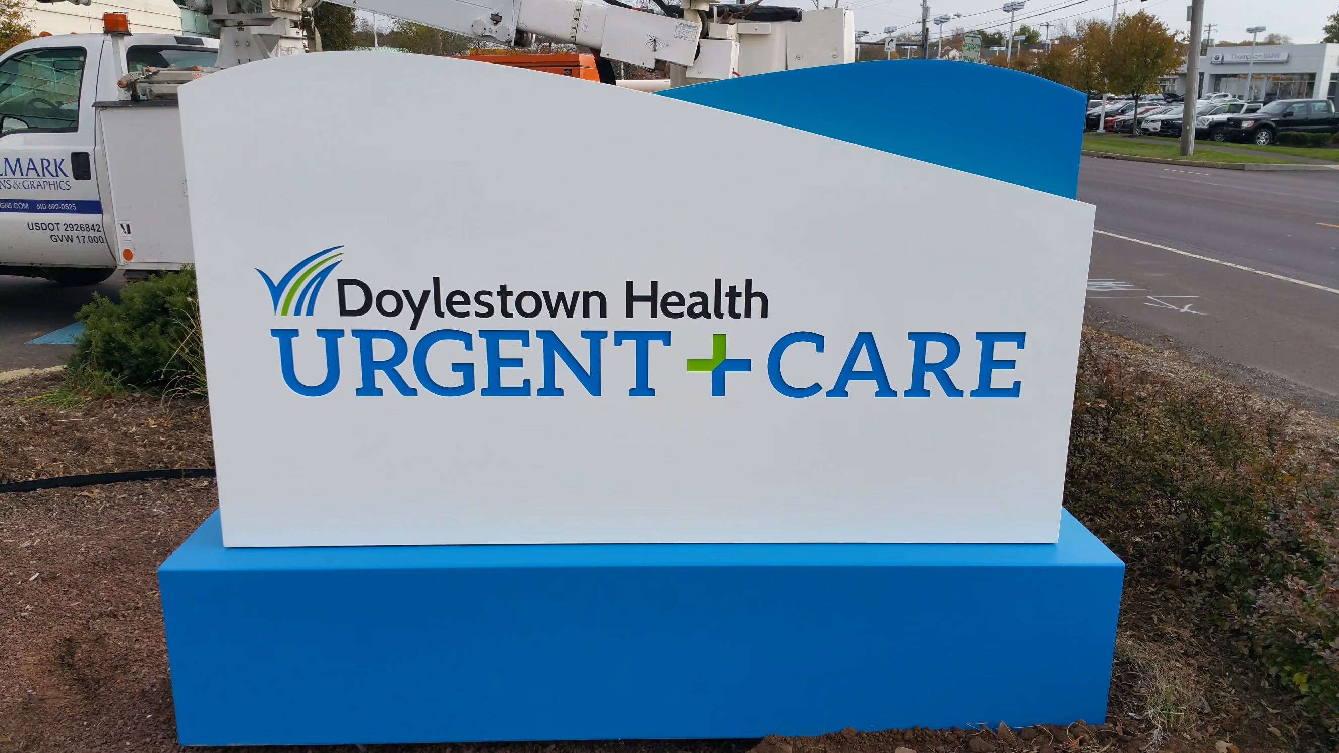 Large monument sign with routered aluminum face with colored acrylic behind