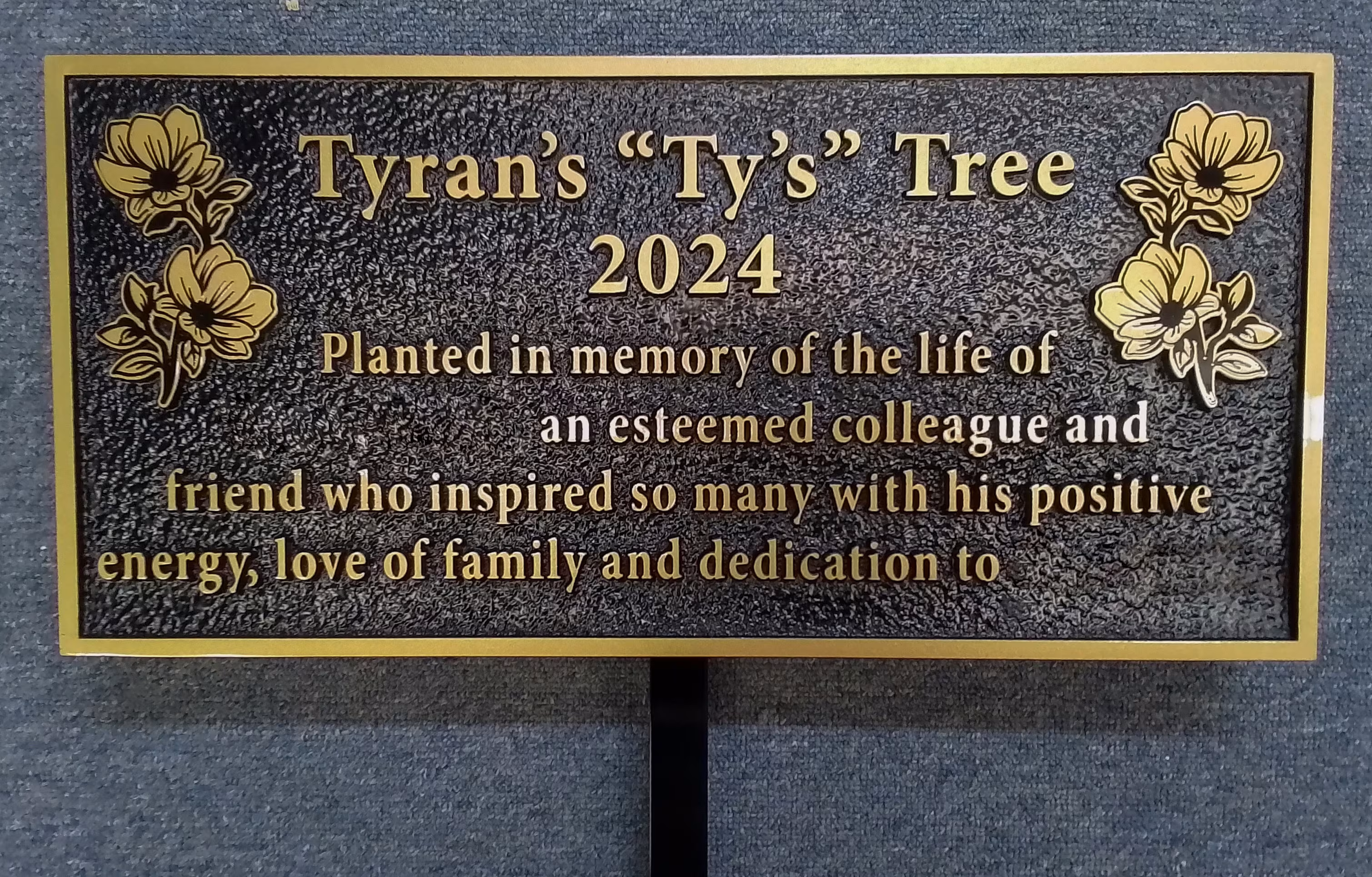Precision-tooled bronze garden plaque on a black, metal stake