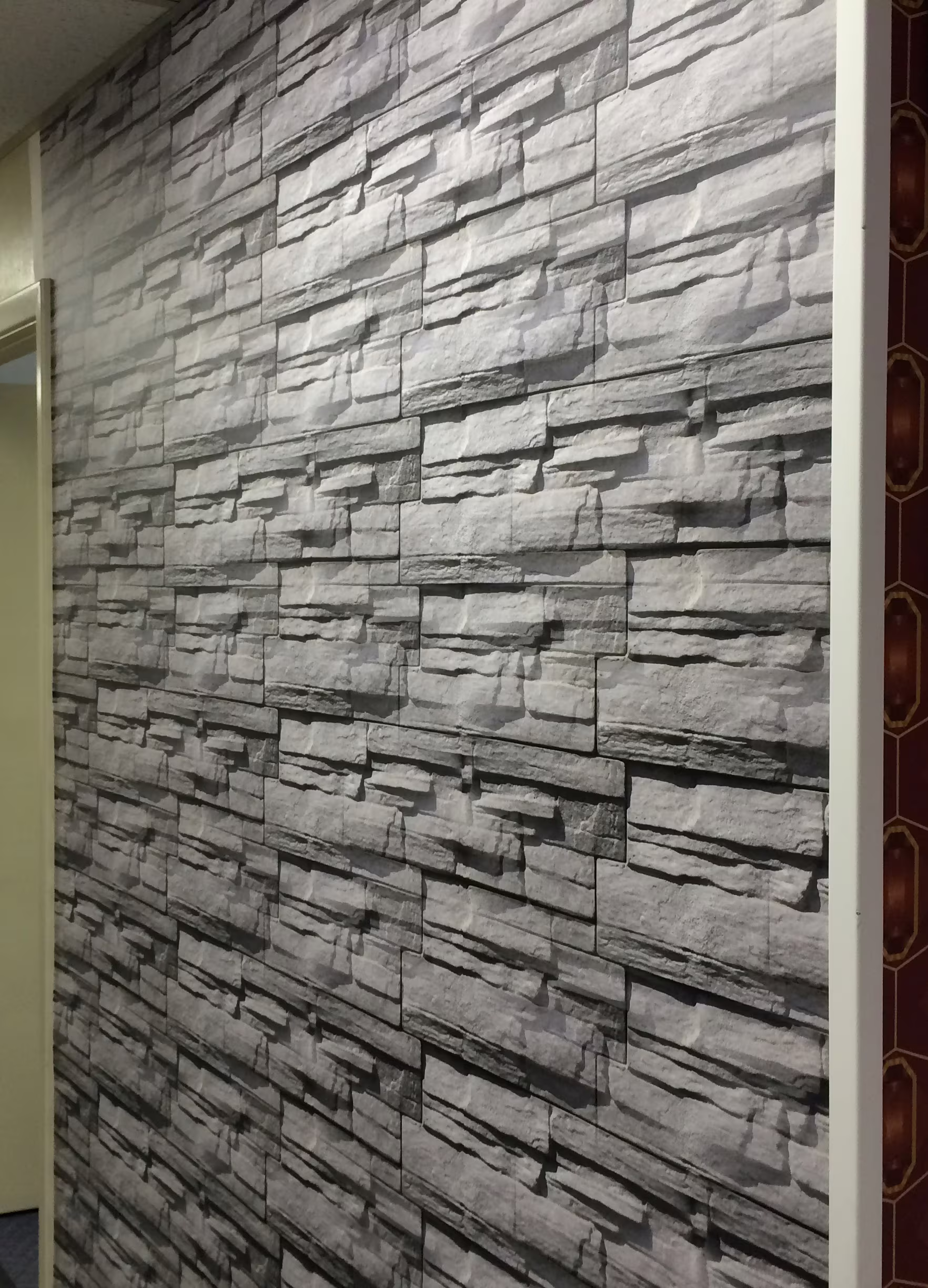 Large vinyl wall graphic depicting a stone wall