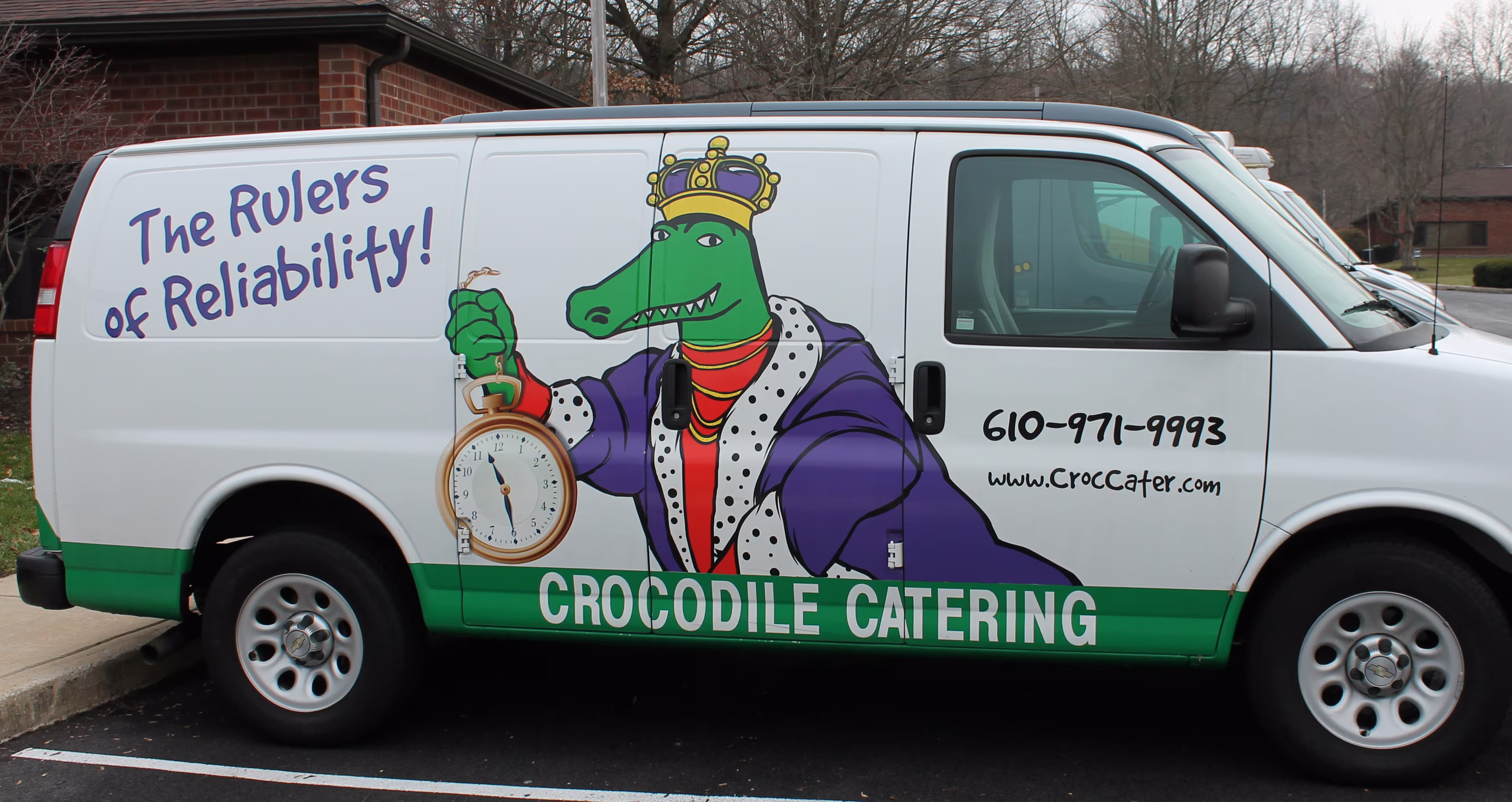 Custom branding graphics and lettering on the side of a cargo van