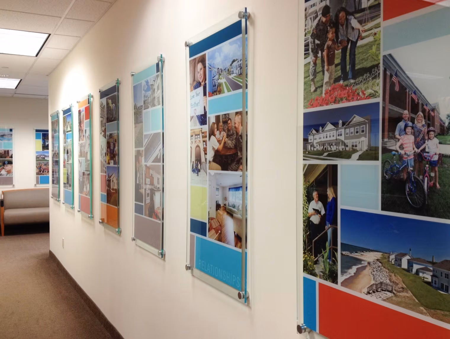 Hallway of multiple large acrylic wall panels mounted on standoffs