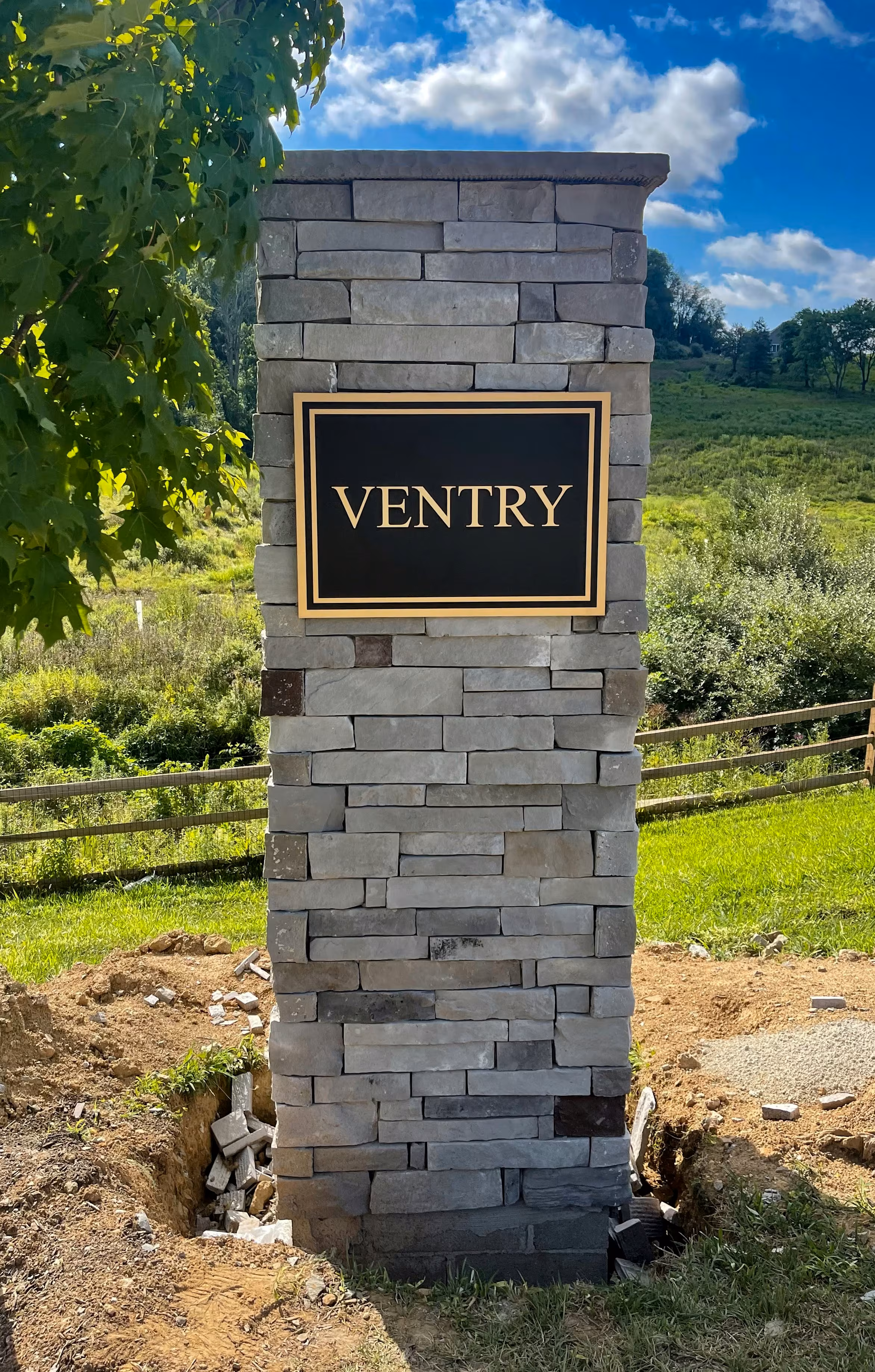 Precision-tooled plaque on a natural stone pillar