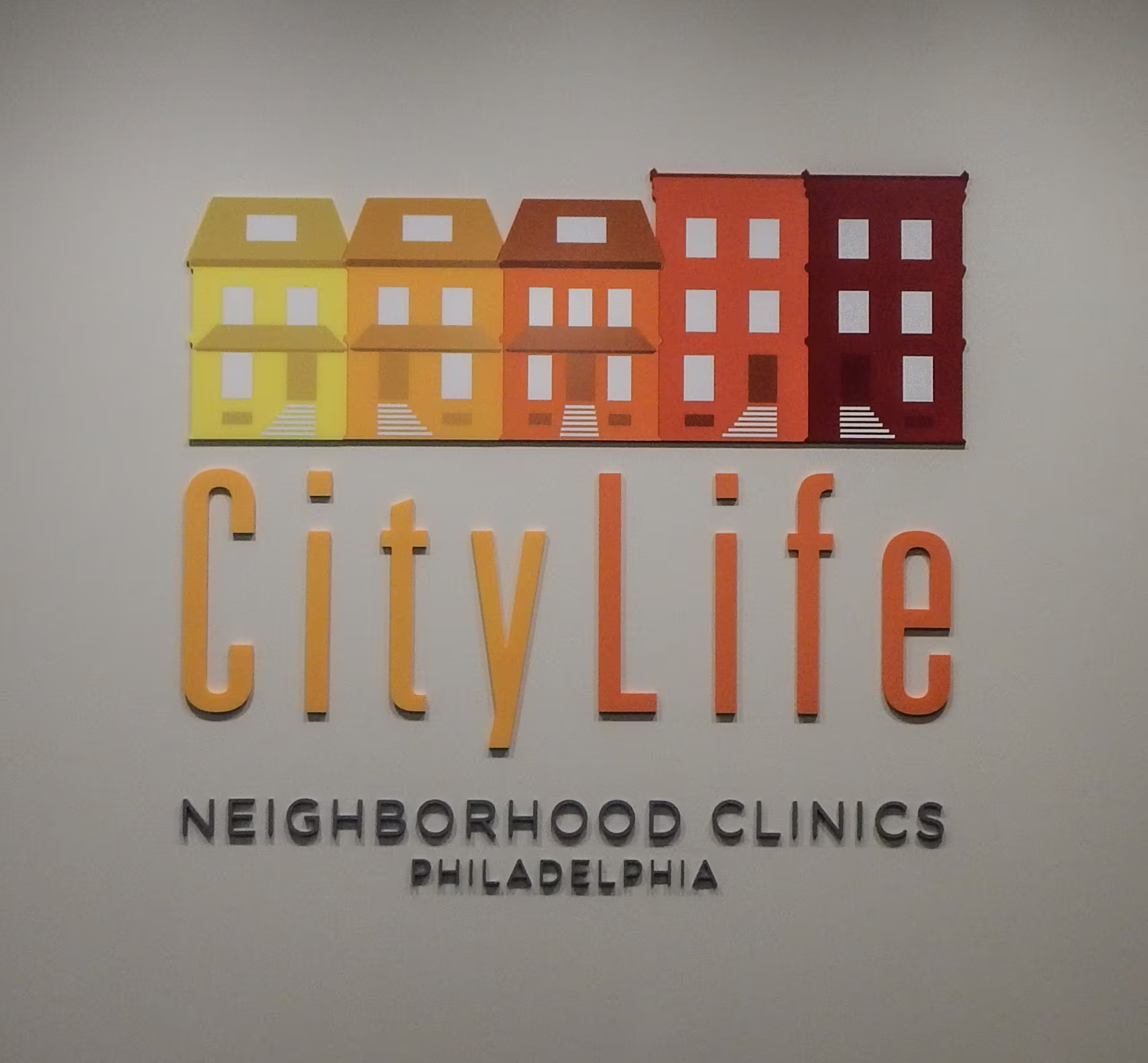Multi-colored acrylic dimensional letters and logo mounted flush on an interior wall