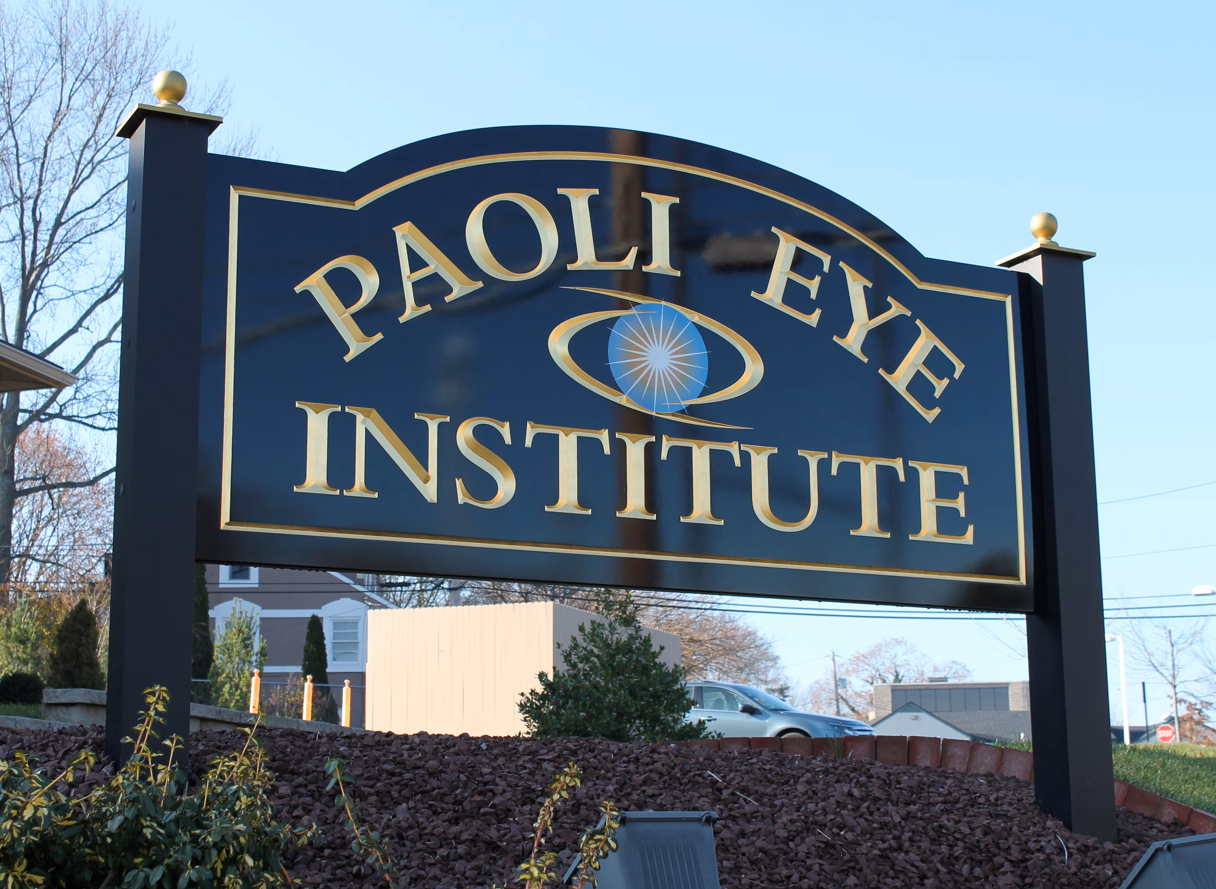 Carved HDU sign with projecting letters mounted between two black posts