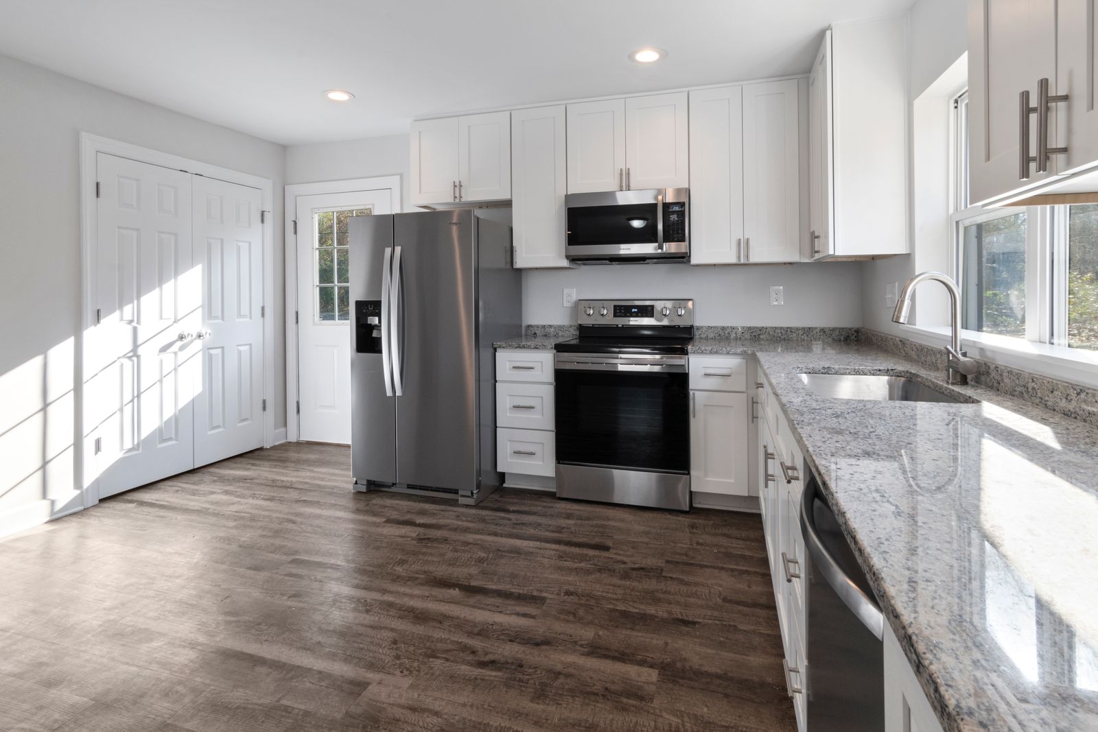 Modern kitchen with stainless steel appliances and granite countertops