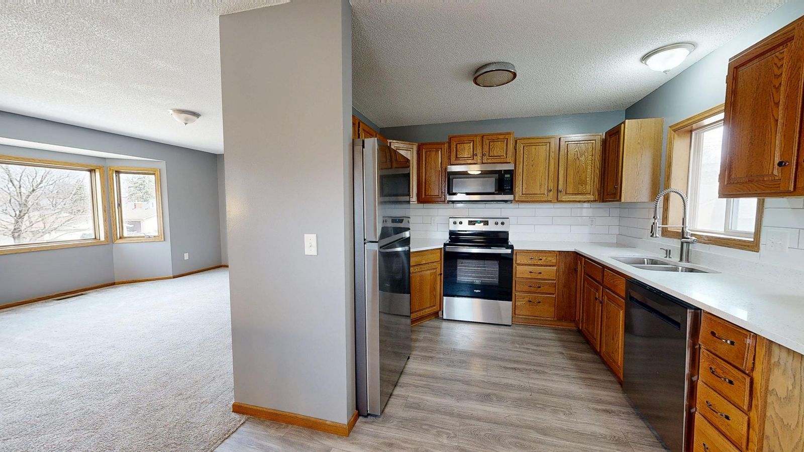 Open-concept kitchen and living area with wood cabinetry