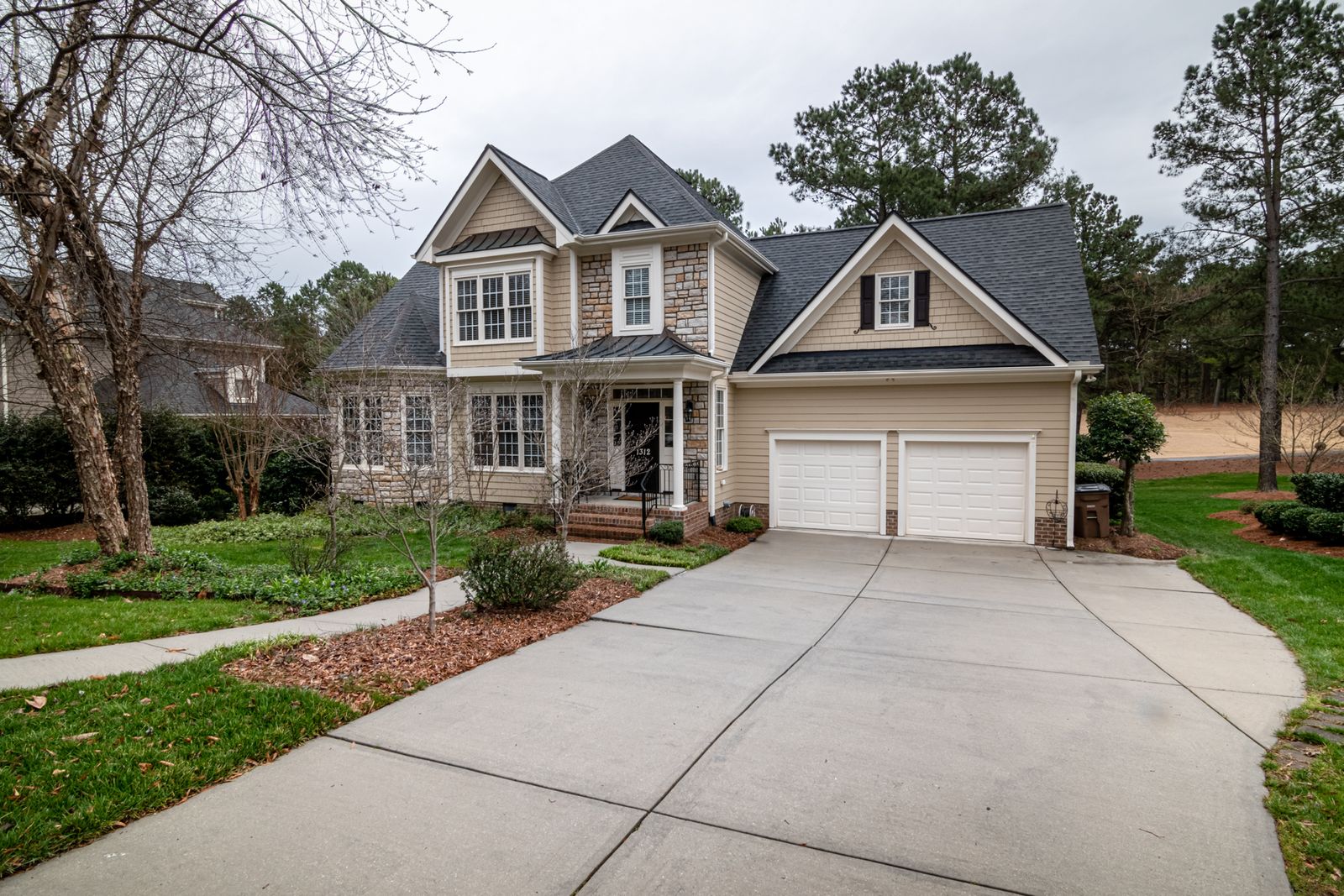 Charming suburban home with a two-car garage and manicured lawn