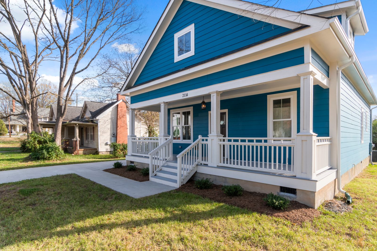 Cozy blue suburban house with a white front porch