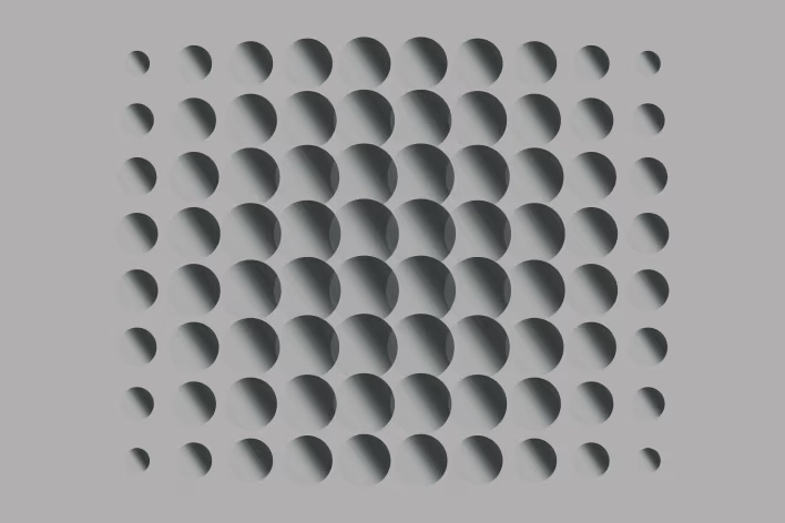 Array of three-dimensional spheres arranged in a grid, scaling larger toward the center and smaller at the edges with soft shading.