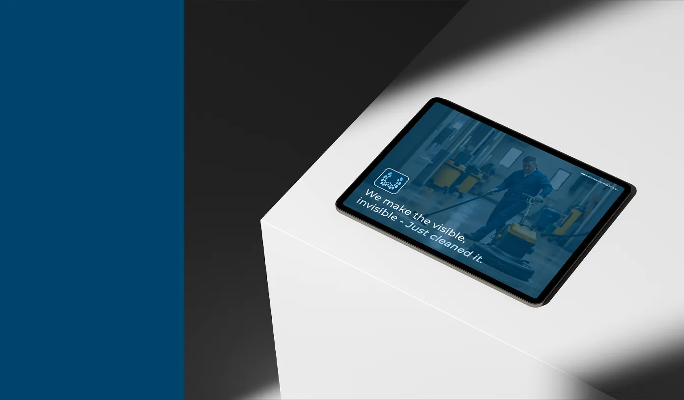 Tablet displaying a cleaner operating a floor-cleaning machine in a hallway with the text 'We make the visible, invisible - Just cleaned it.'