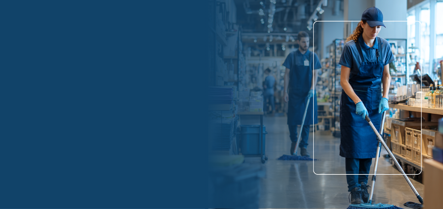 Retail workers wearing aprons and gloves cleaning a store floor with mops.