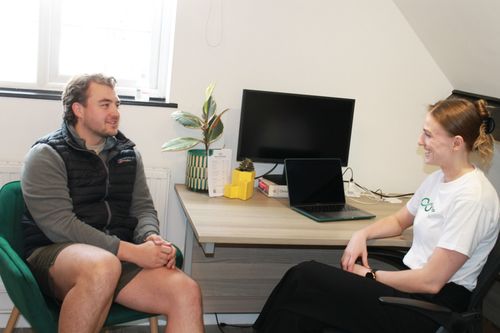Explaining a rehabilitation plan to a client at Resync Physiotherapy