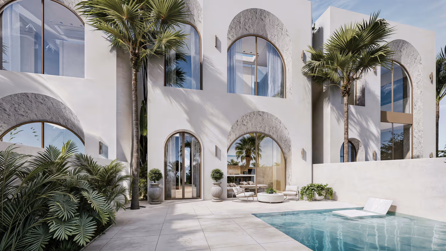 Modern white building with large arched windows, palm trees, outdoor seating, and a swimming pool.