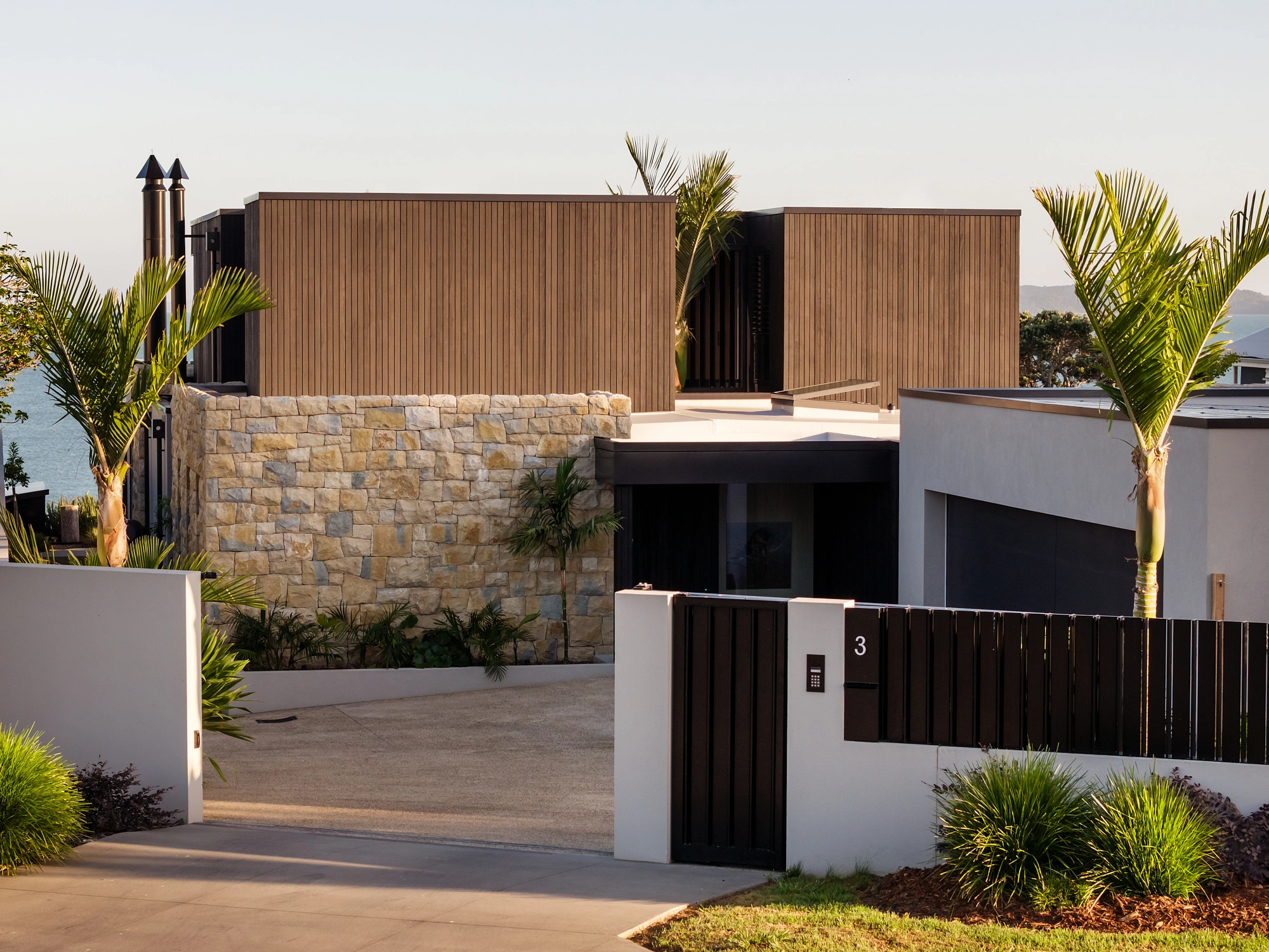 Luxury coastal home construction featuring detailed stone work and accoya cladding by Graham Mauger Builders