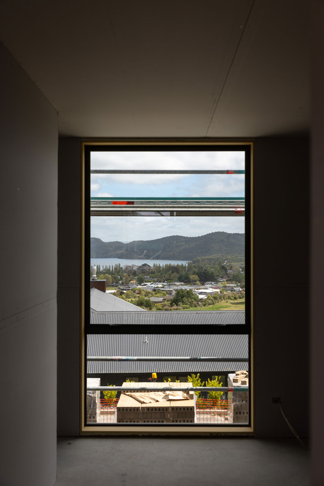 A bedroom window frames the view over Kinloch Village.