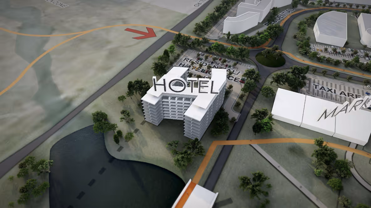 3D model of a hotel building near a water body with surrounding roads and parking areas labeled.