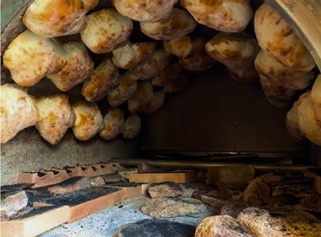 A close up of food cooking in an oven.