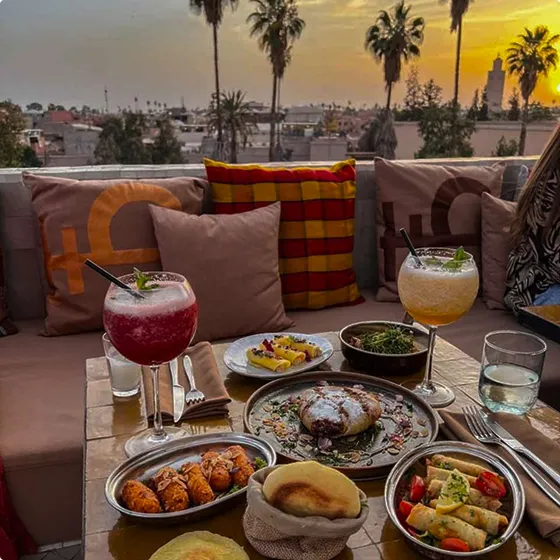 A table topped with plates of food and drinks.
