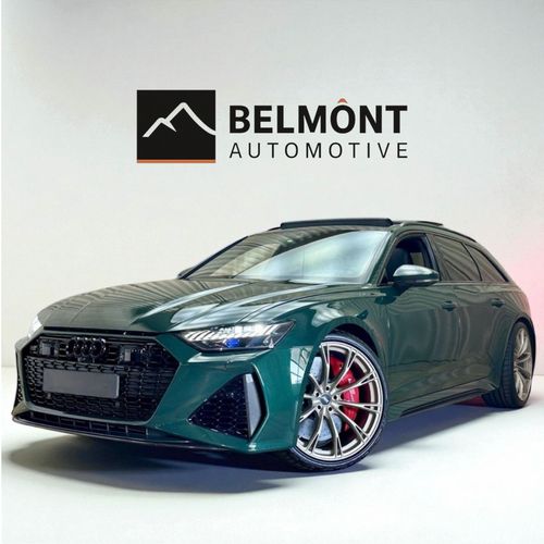 Dark green Audi station wagon with sporty wheels and red brake calipers displayed in front of a Belmont Automotive logo.