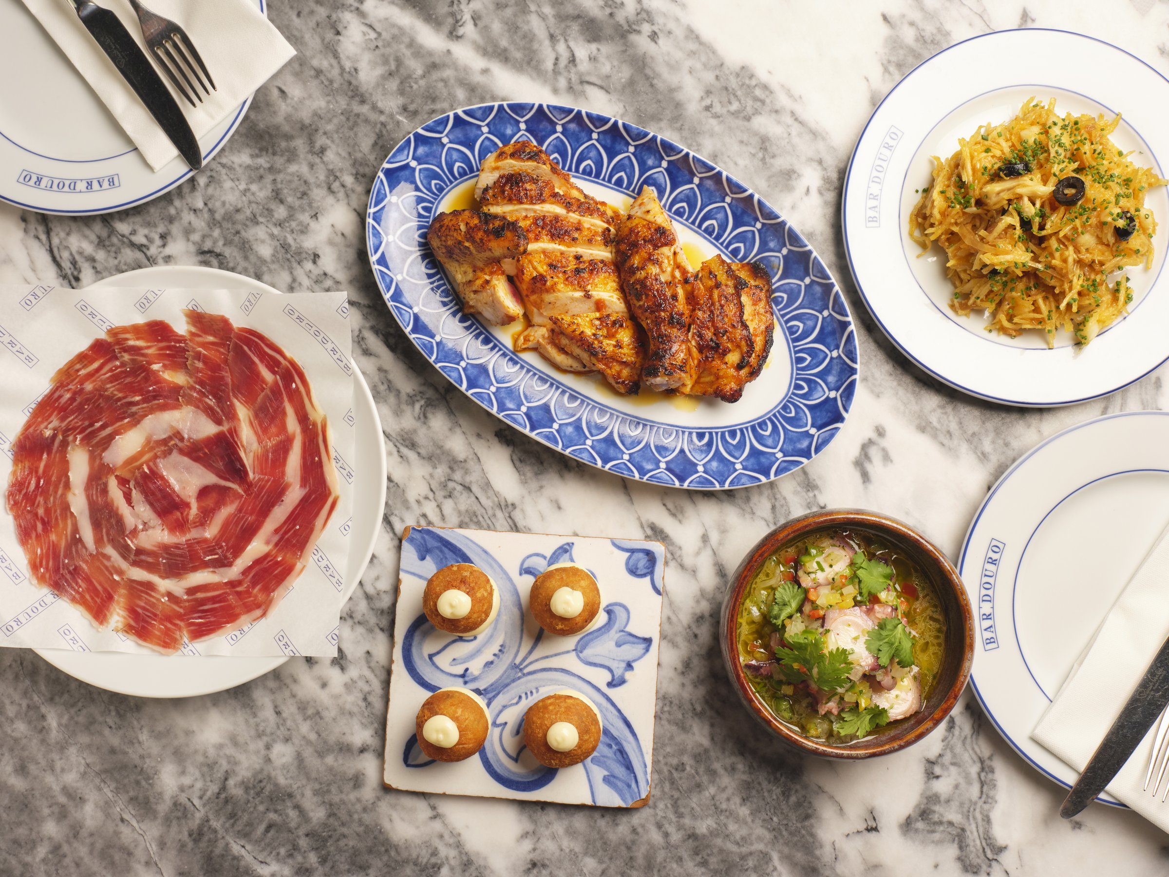 A spread of Bar Douro dishes on marble table for the Christmas group menu