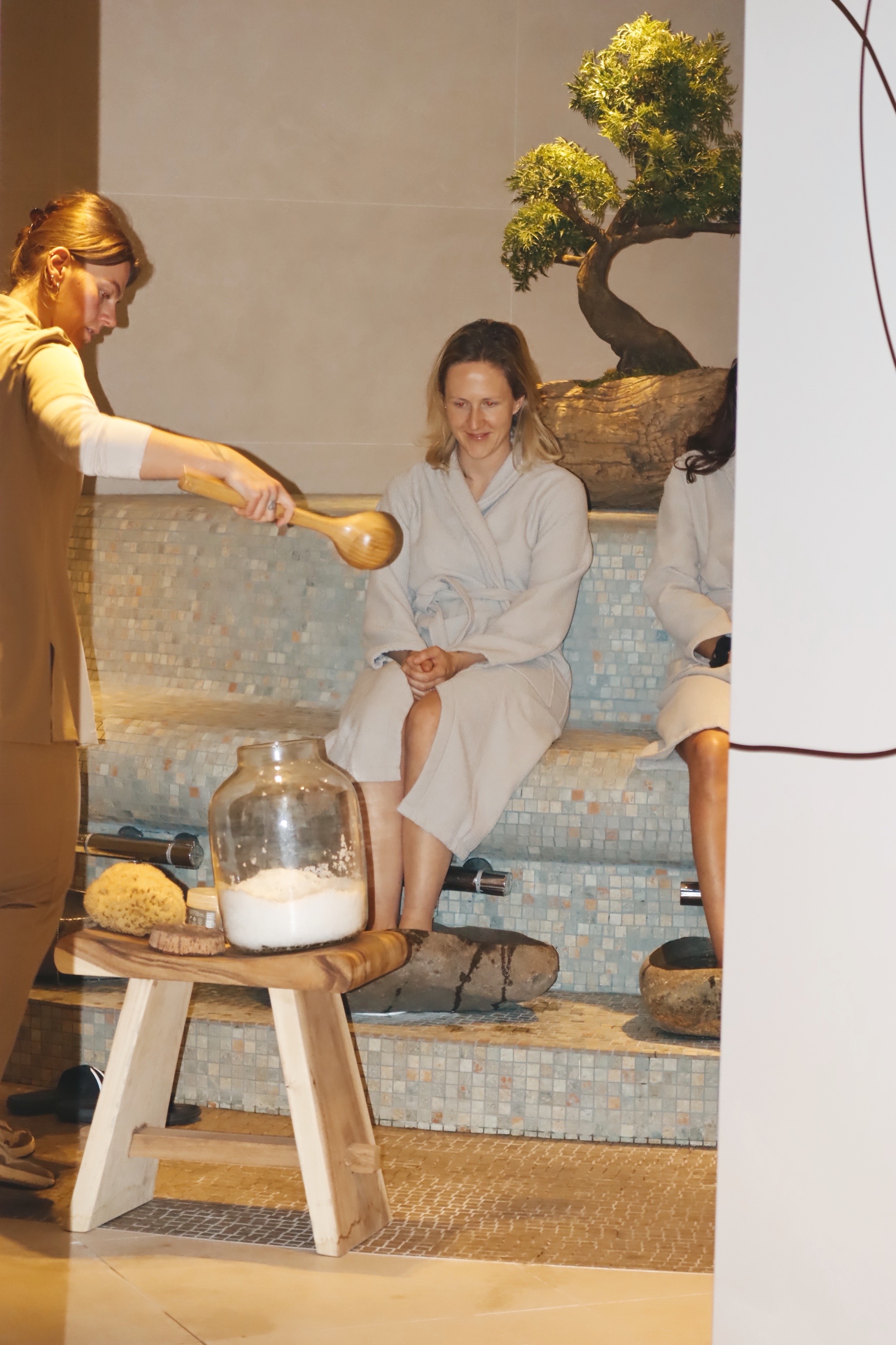 Close-up of a hand gently touching a person in a steam room