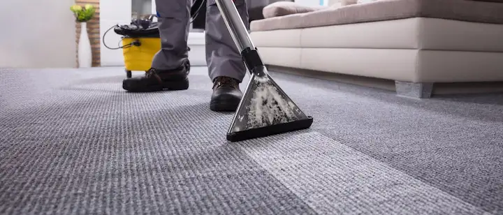 an image of a person cleaning carpet