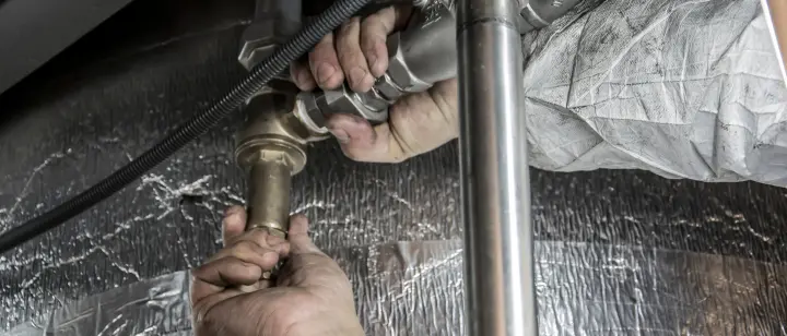 plumber fixing a geyser