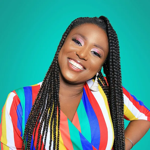 Woman in a colorful dress in front of the blue background