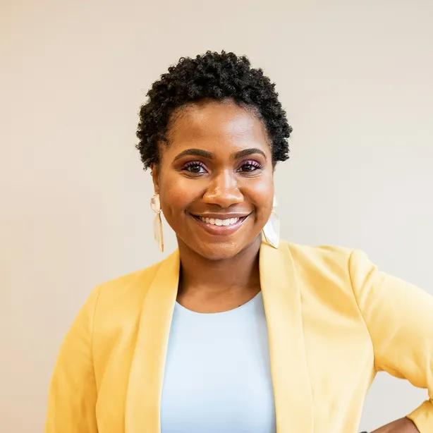 Woman with short curly hair wearing yellow jacket