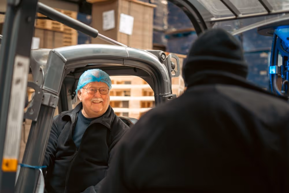 a man in a forklift smiling
