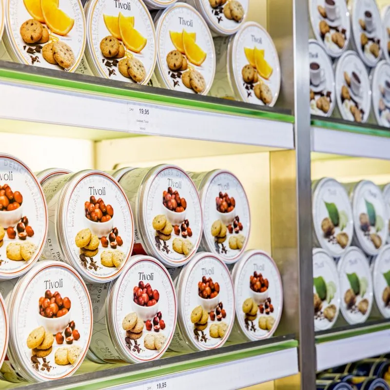White Tivoli cookie tins stacked on store shelves in Denmark