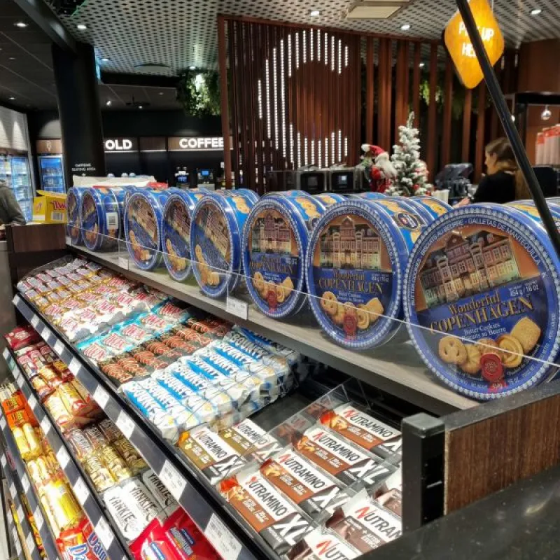 Blue Danish butter cookie tins displayed at a shop counter in Denmark