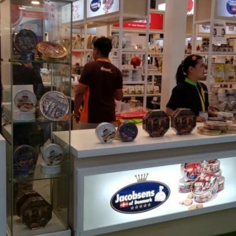 Staff at an illuminated Jacobsens of Denmark sales counter in Indonesia