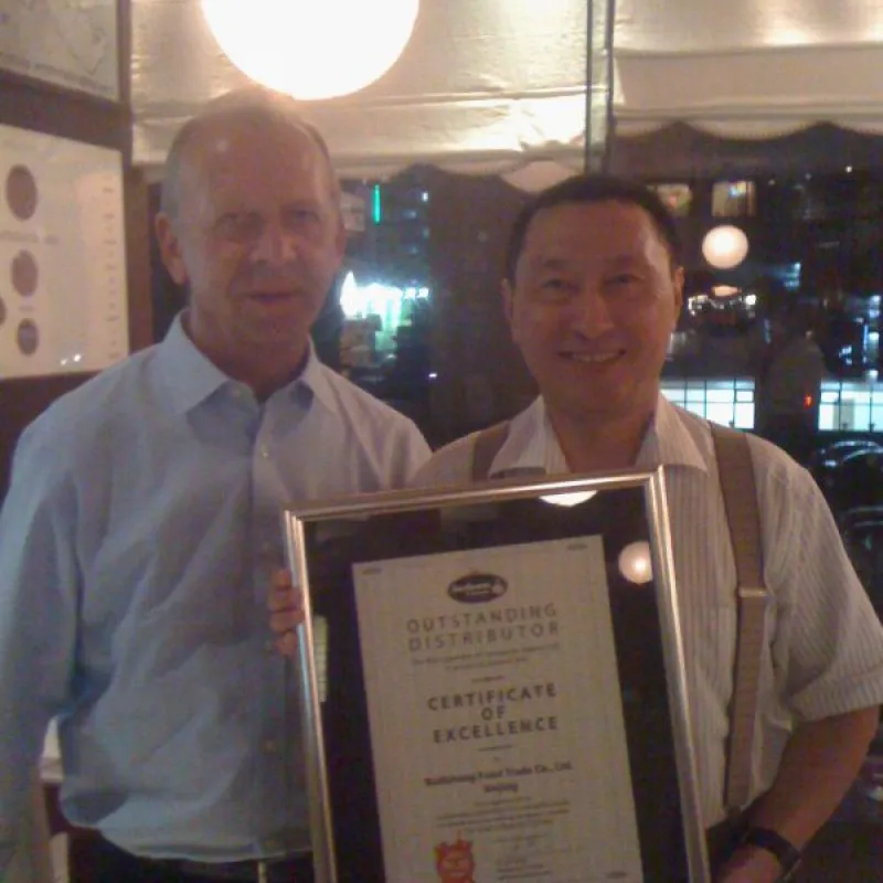 Two men holding a framed certificate of excellence
