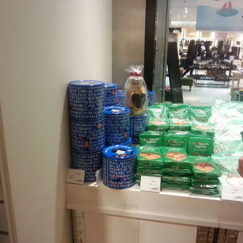 Blue and green cookie tins and packs displayed in a department store in Japan