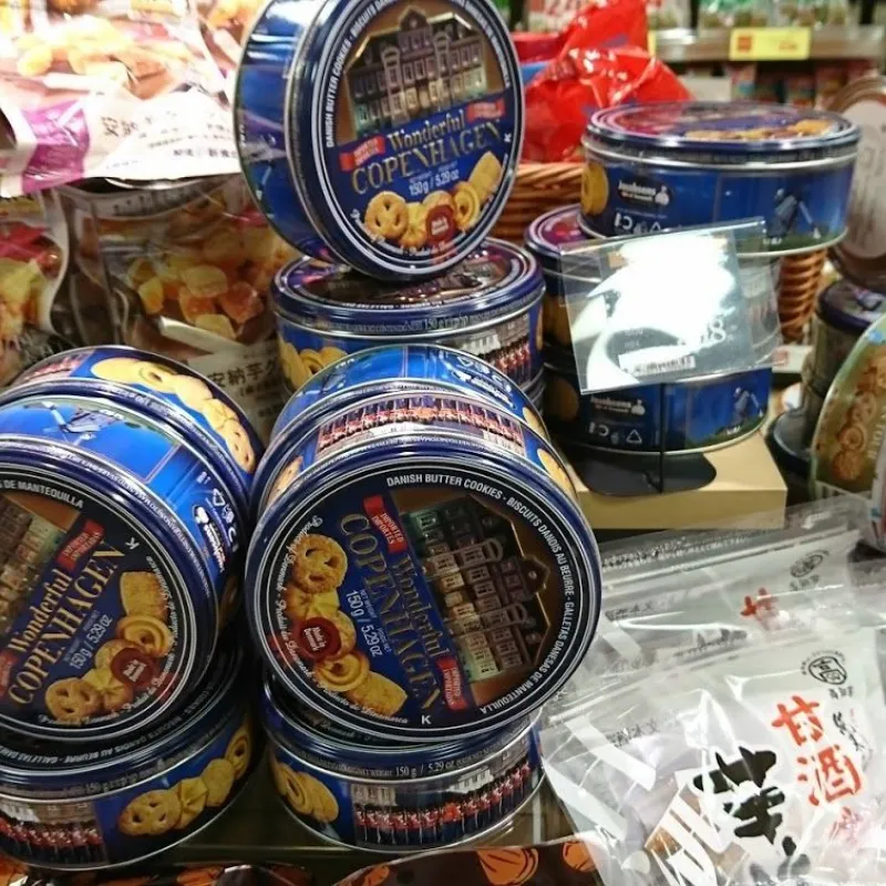 Blue Danish butter cookie tins stacked on a store table in Japan