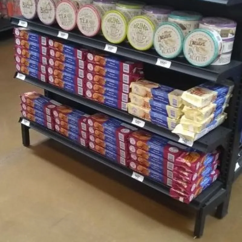 Supermarket shelves with cookie tins and biscuit packs in Mexico