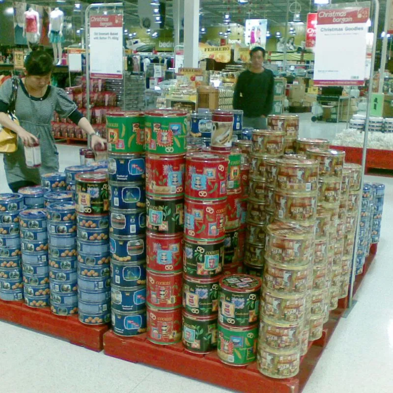 Pallet display of assorted Danish cookie tins in a supermarket in New Zealand