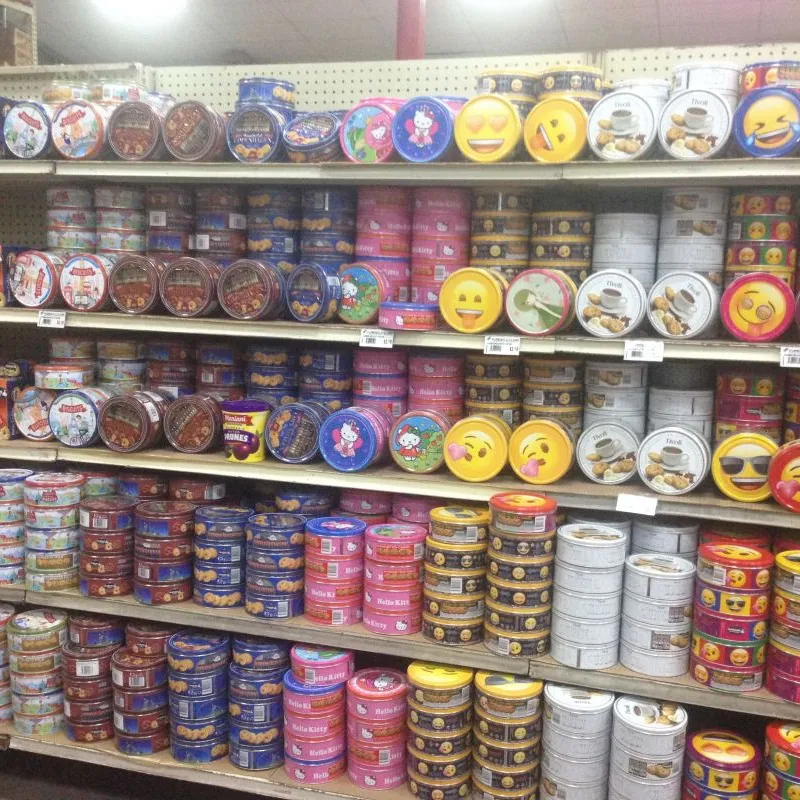 Shelves full of assorted Danish cookie tins in a Philippine supermarket
