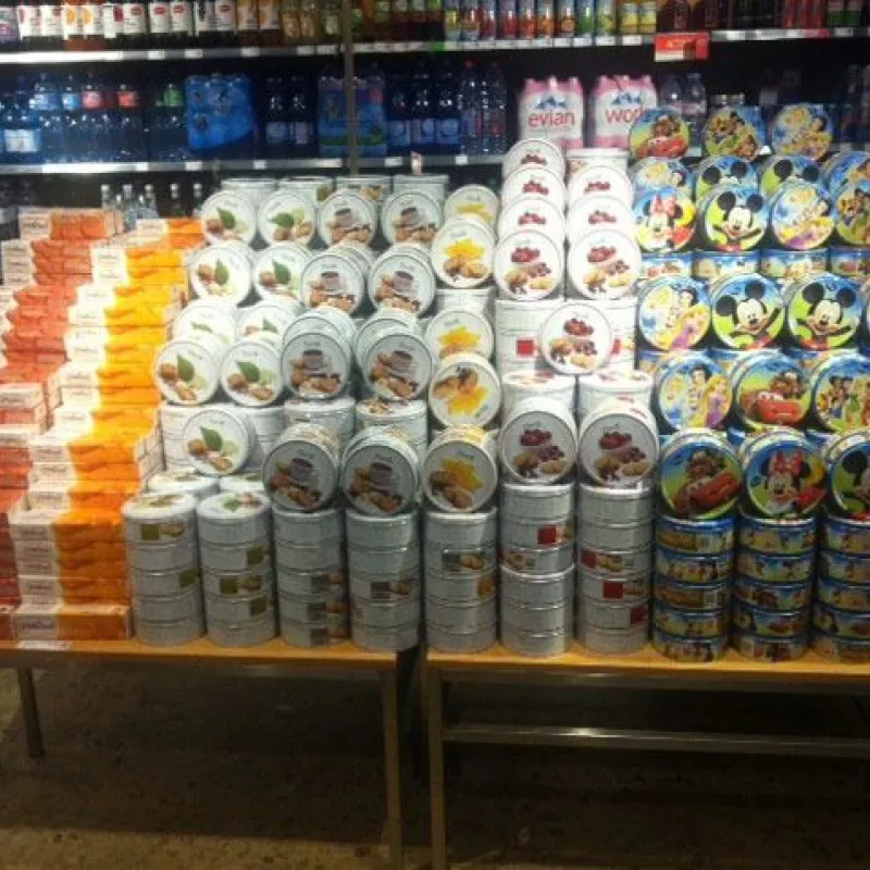 Large display of assorted Danish cookie tins in a supermarket in Switzerland