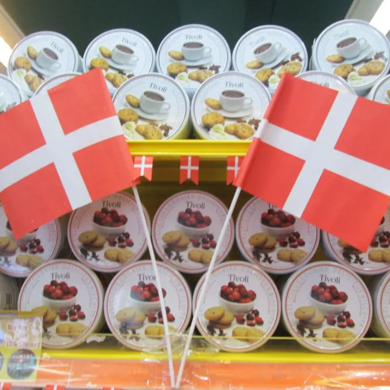 Danish flags above stacked white cookie tins in a store in Taiwan