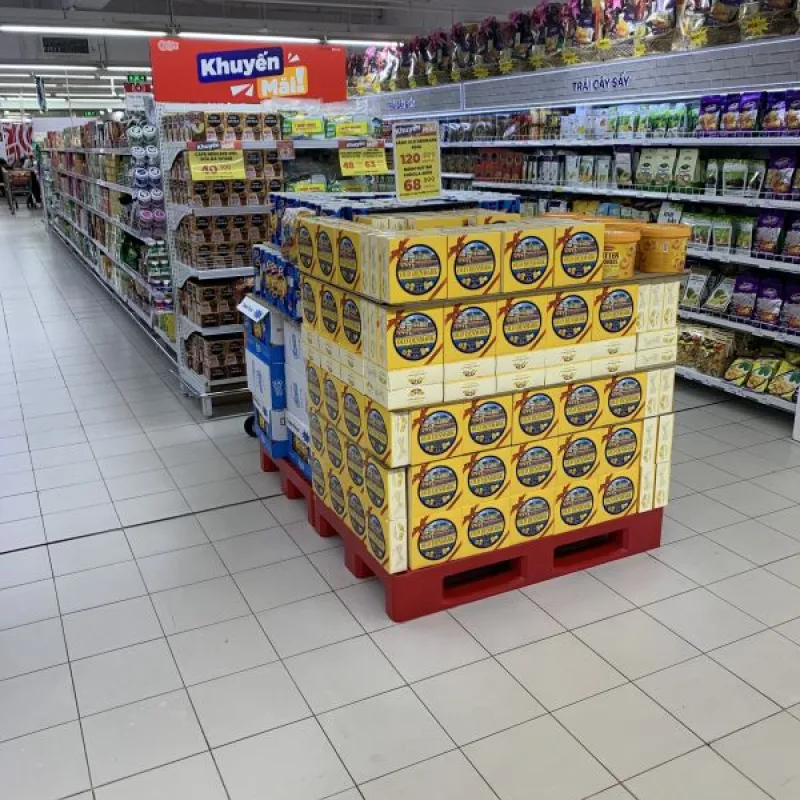 Pallet of Danish butter cookie tins in a supermarket aisle in Vietnam