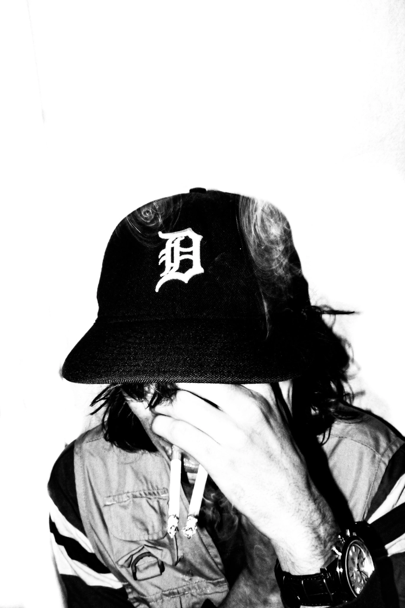 a black and white photo of a man with a cigarette 