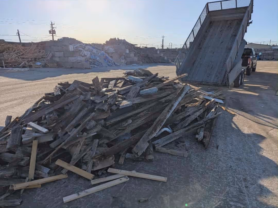Dump trailer dumping a load of wood