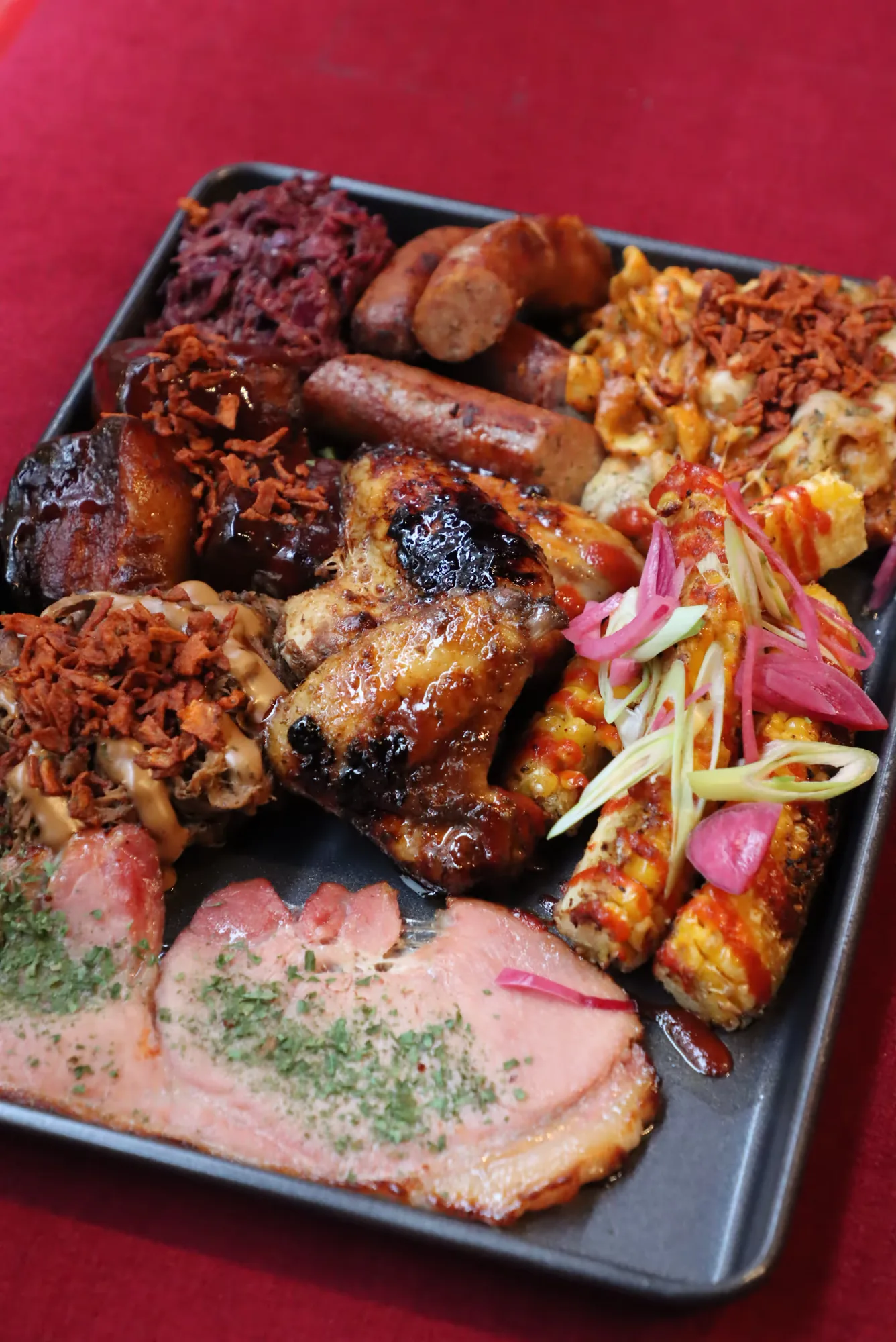 Sharing trays of smoked meats and sides